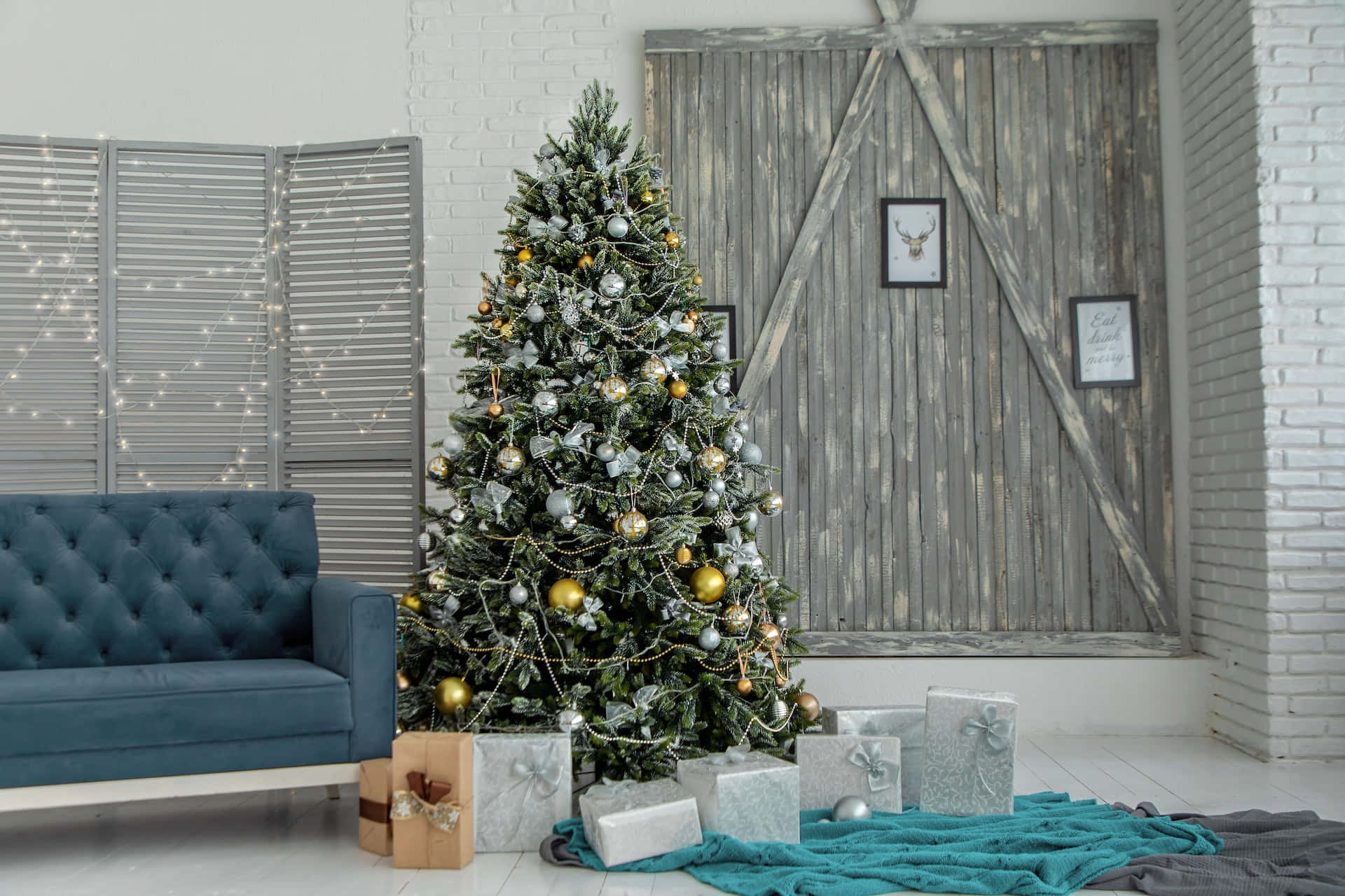 A Blue Couch And A Christmas Tree In Front Of A Wooden Wall