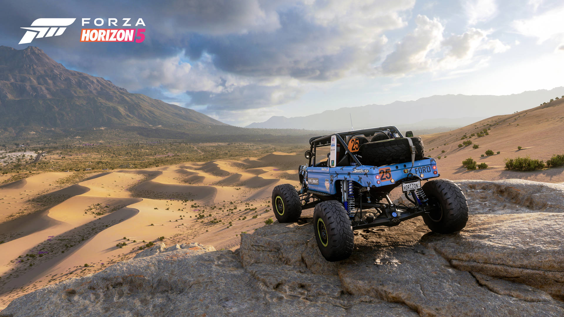 A Blue Jeep Is Driving On A Rocky Hill Background