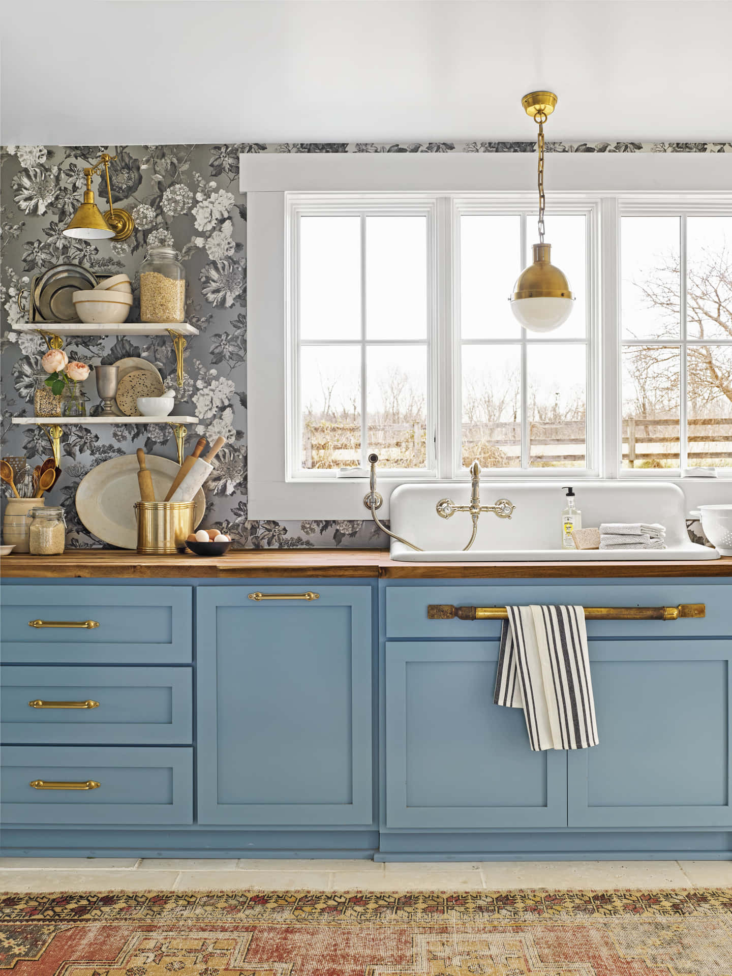 A Blue Kitchen With A Rug And Blue Cabinets Background