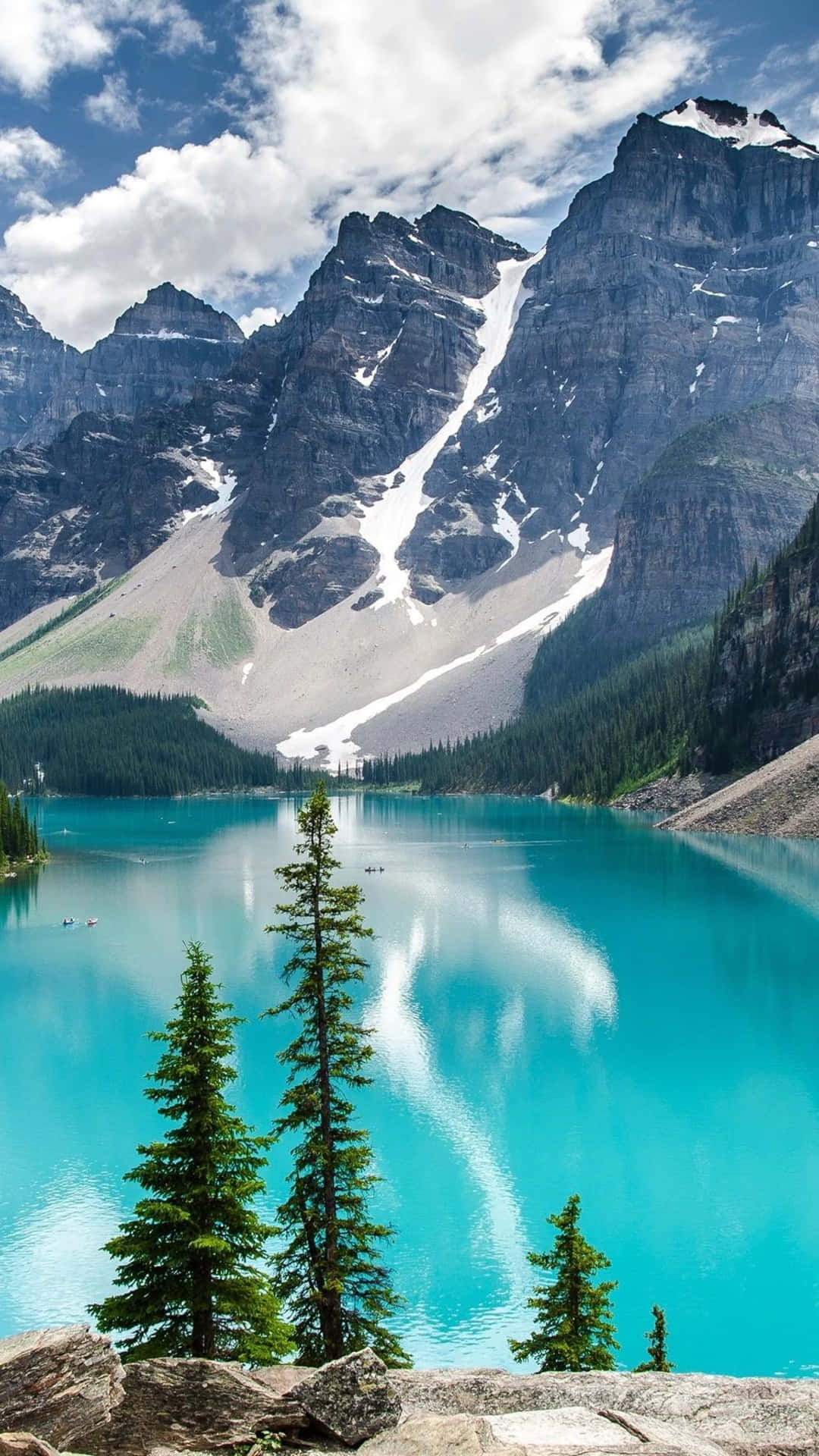 A Blue Lake Surrounded By Mountains And Trees Background
