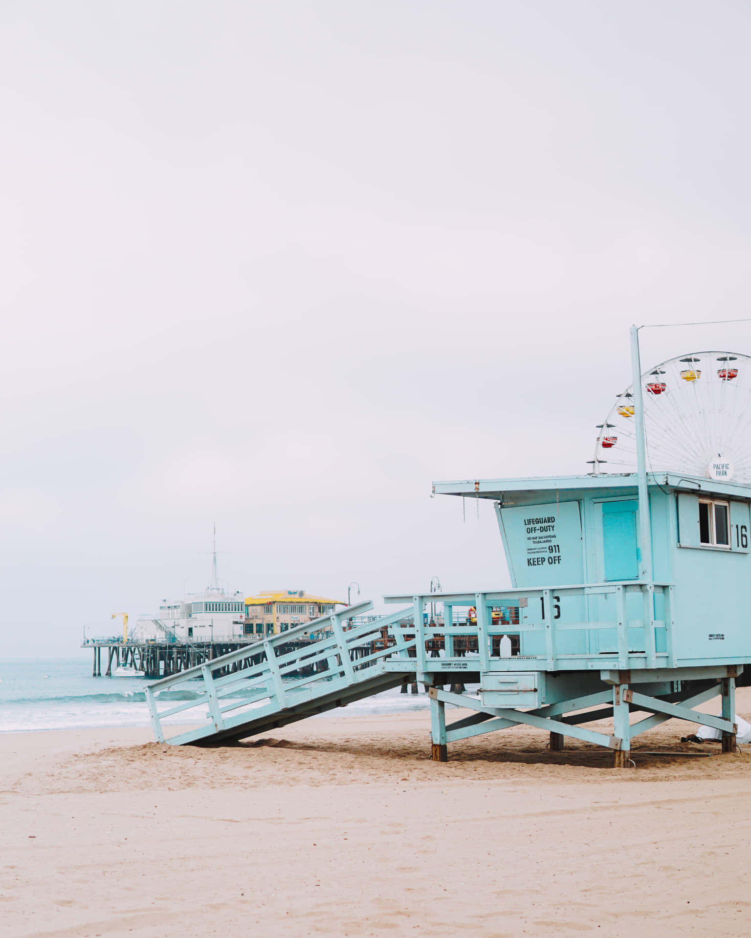 A Blue Lifeguard Tower On The Beach Background