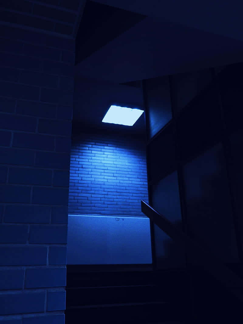 A Blue Light Is Shining On A Brick Wall Background