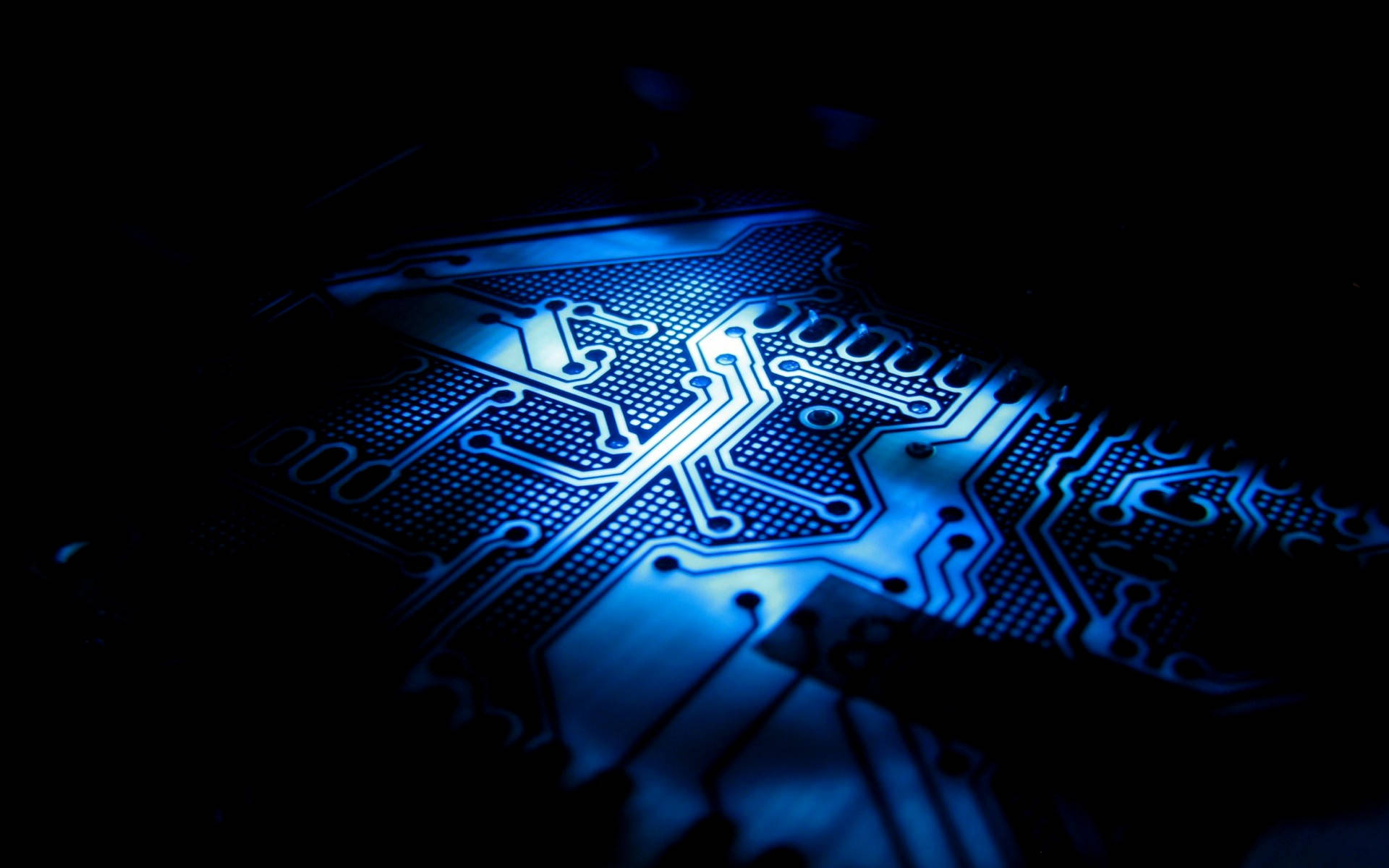 A Blue Light Shining On A Circuit Board Background