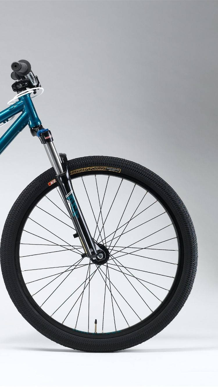 A Blue Mountain Bike Is Shown Against A White Background Background