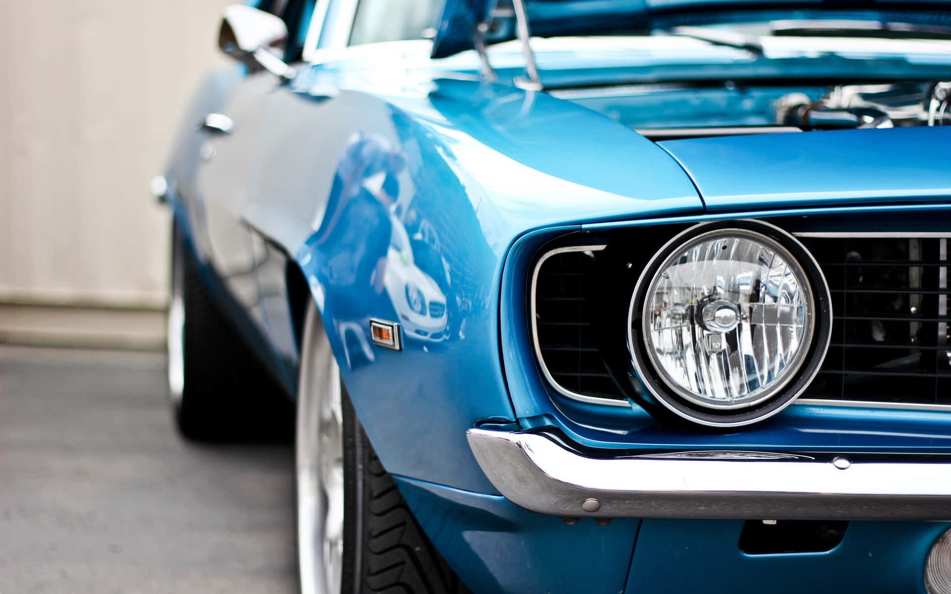 A Blue Muscle Car With The Hood Open