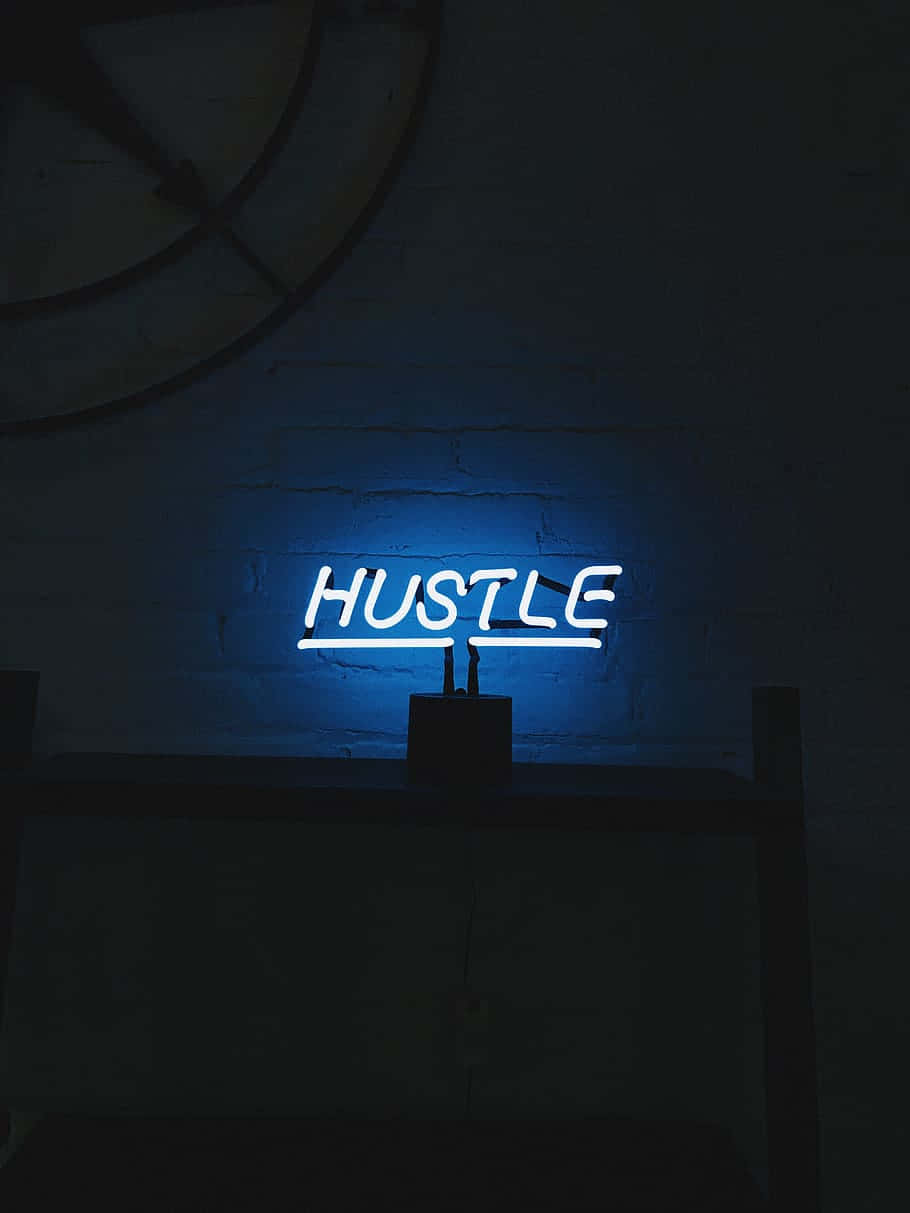 A Blue Neon Sign With The Word Hustle On It