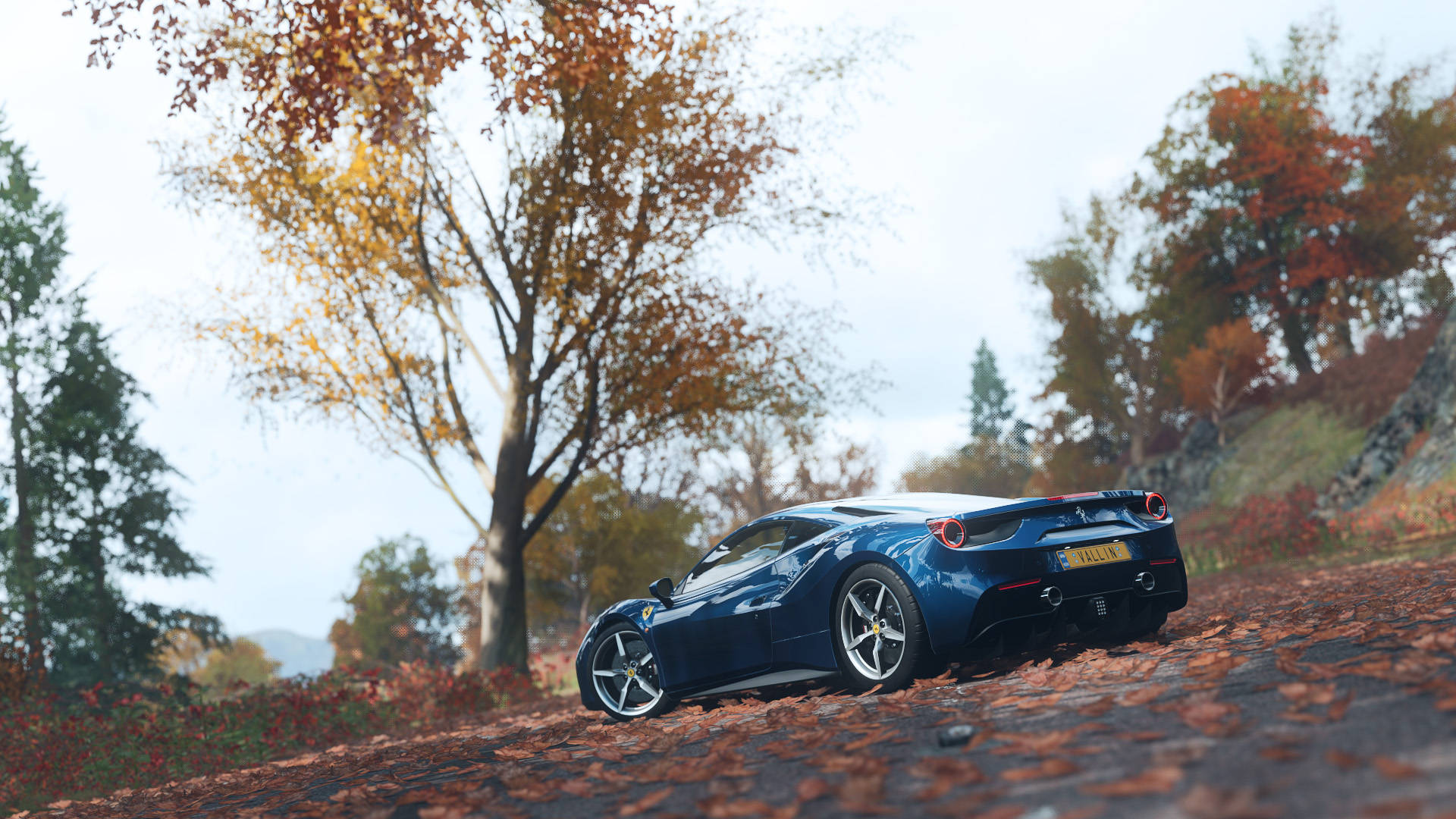 A Blue Sports Car Driving Down A Road In Autumn Background