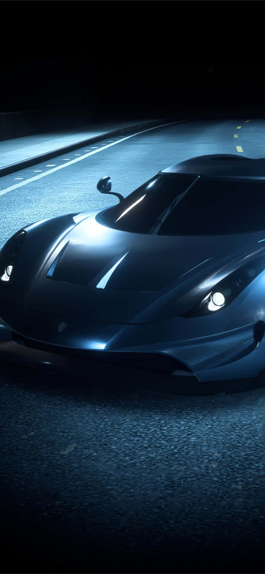 A Blue Sports Car Driving Down The Road At Night