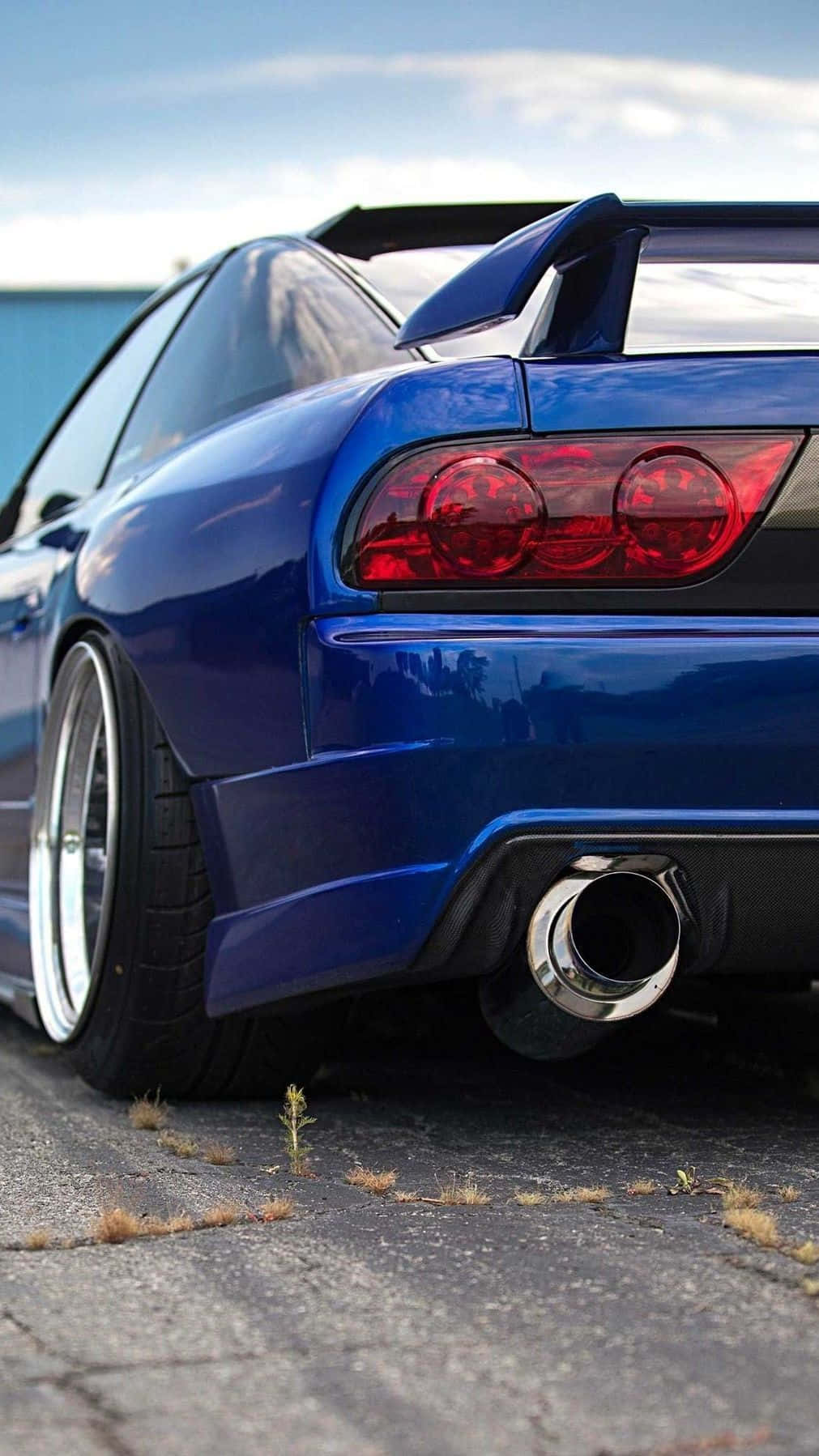 A Blue Sports Car With A Rear End Background