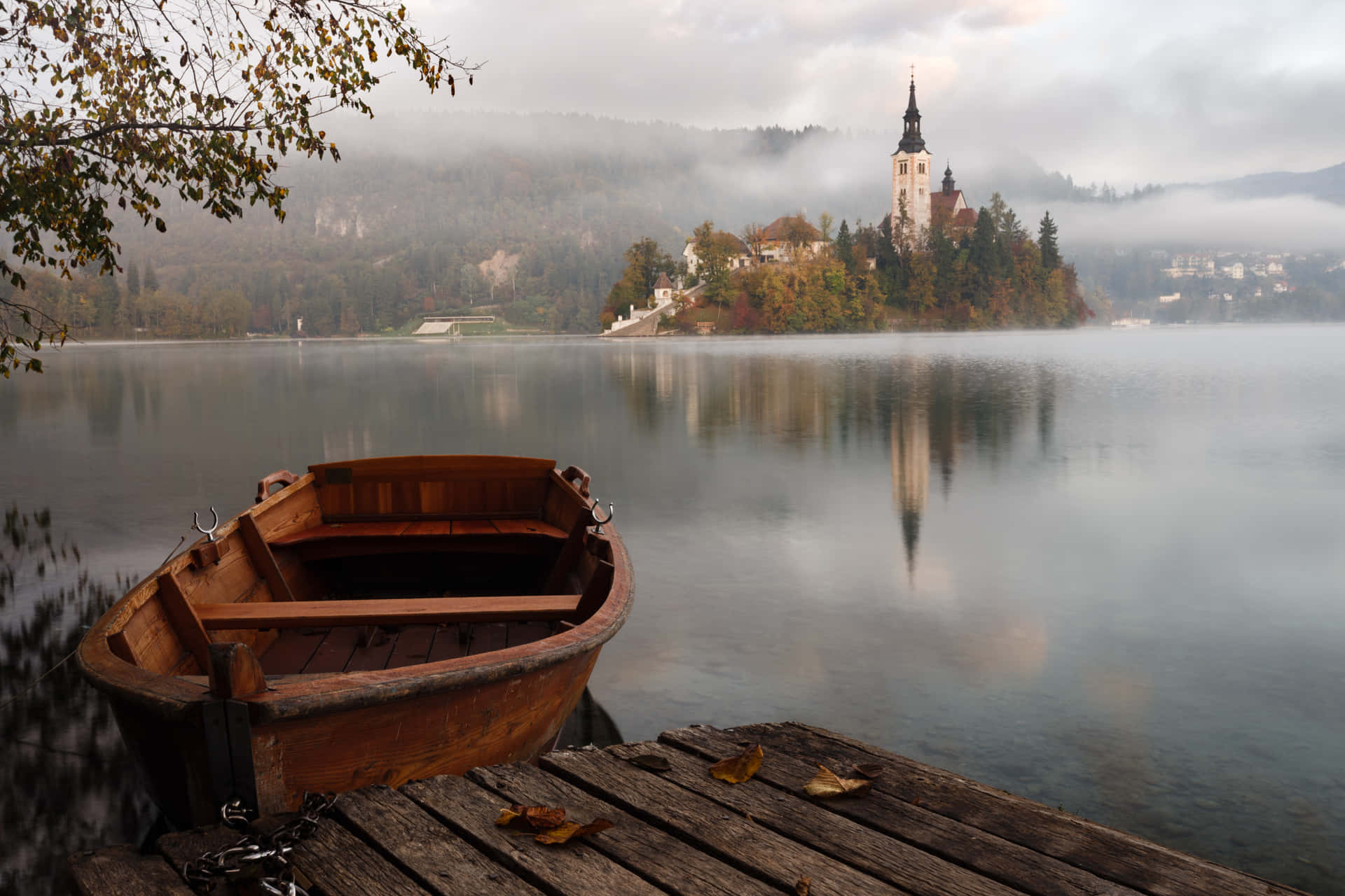 A Boat Docked At A Quay In Lake Bled