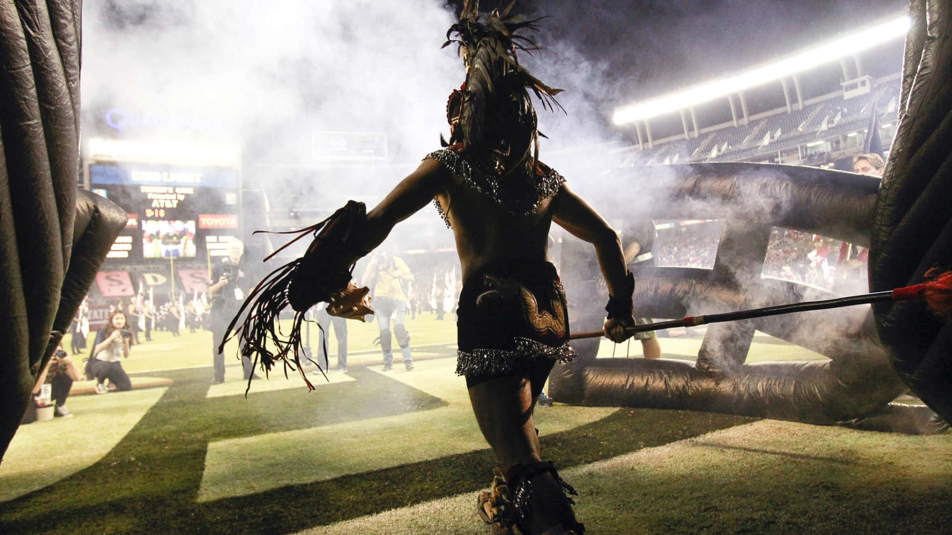 A Bold Aztec Warrior Stands Tall Background
