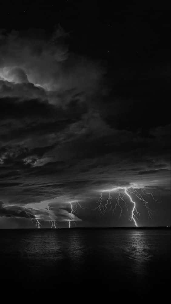 A Bolt Of Electric Blue Lightning Piercing A Night Sky. Background