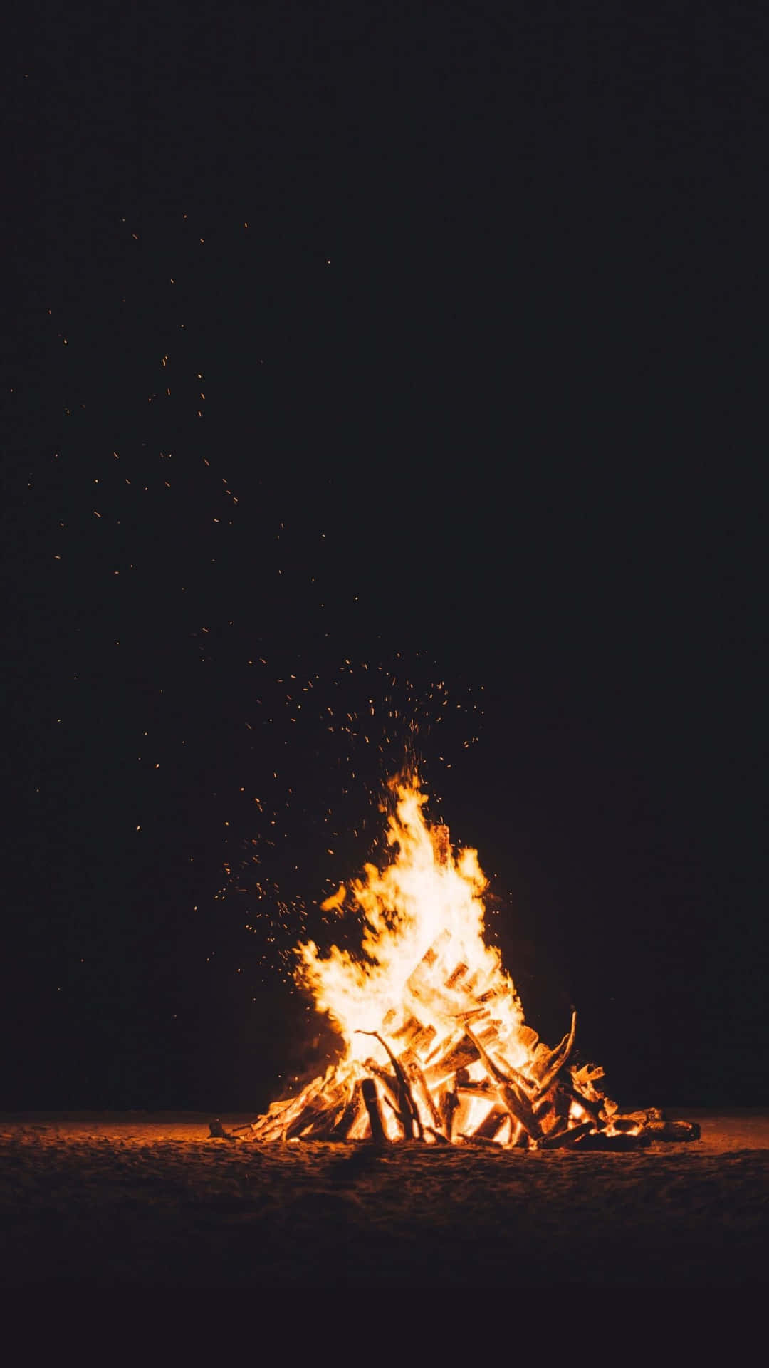 A Bonfire On The Beach At Night Background