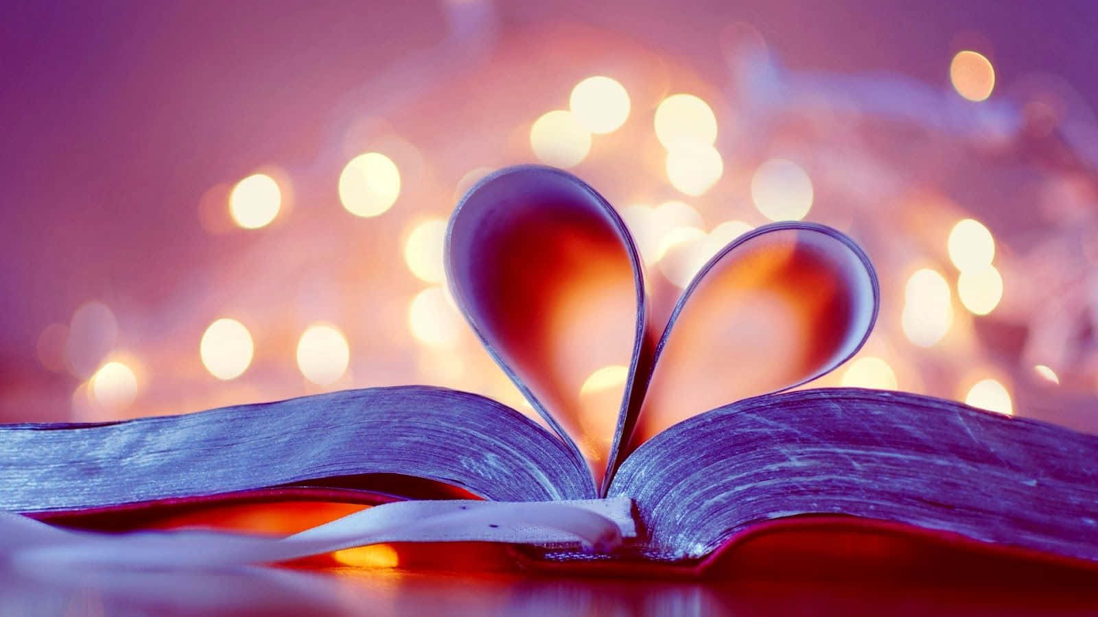 A Book With Hearts On It And Lights Behind It Background