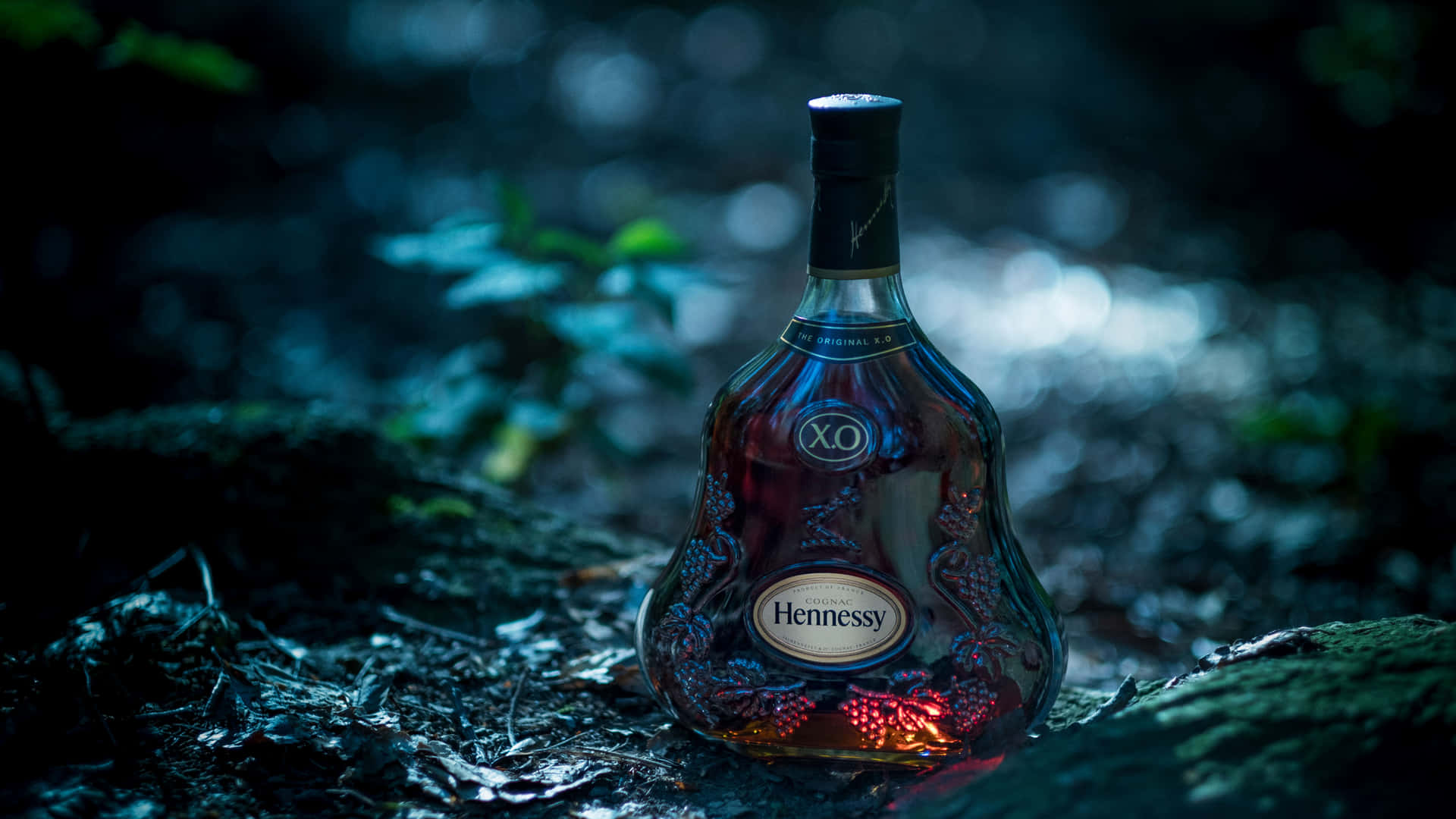 A Bottle Of Liqueur Sitting On The Ground Background