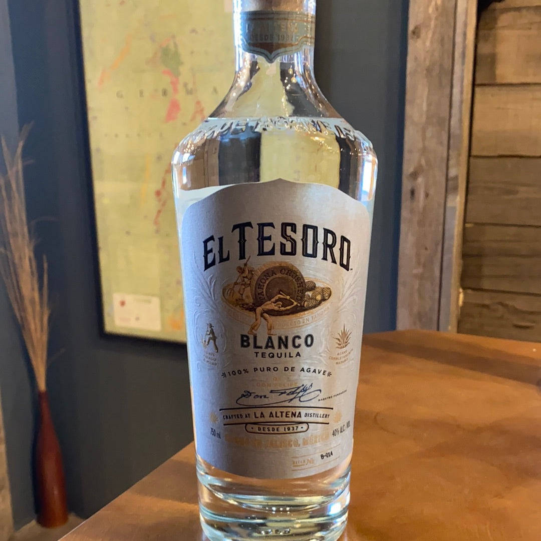 A Bottle Of Premium El Tesoro Blanco Tequila Elegantly Displayed On A Rustic Wooden Table.