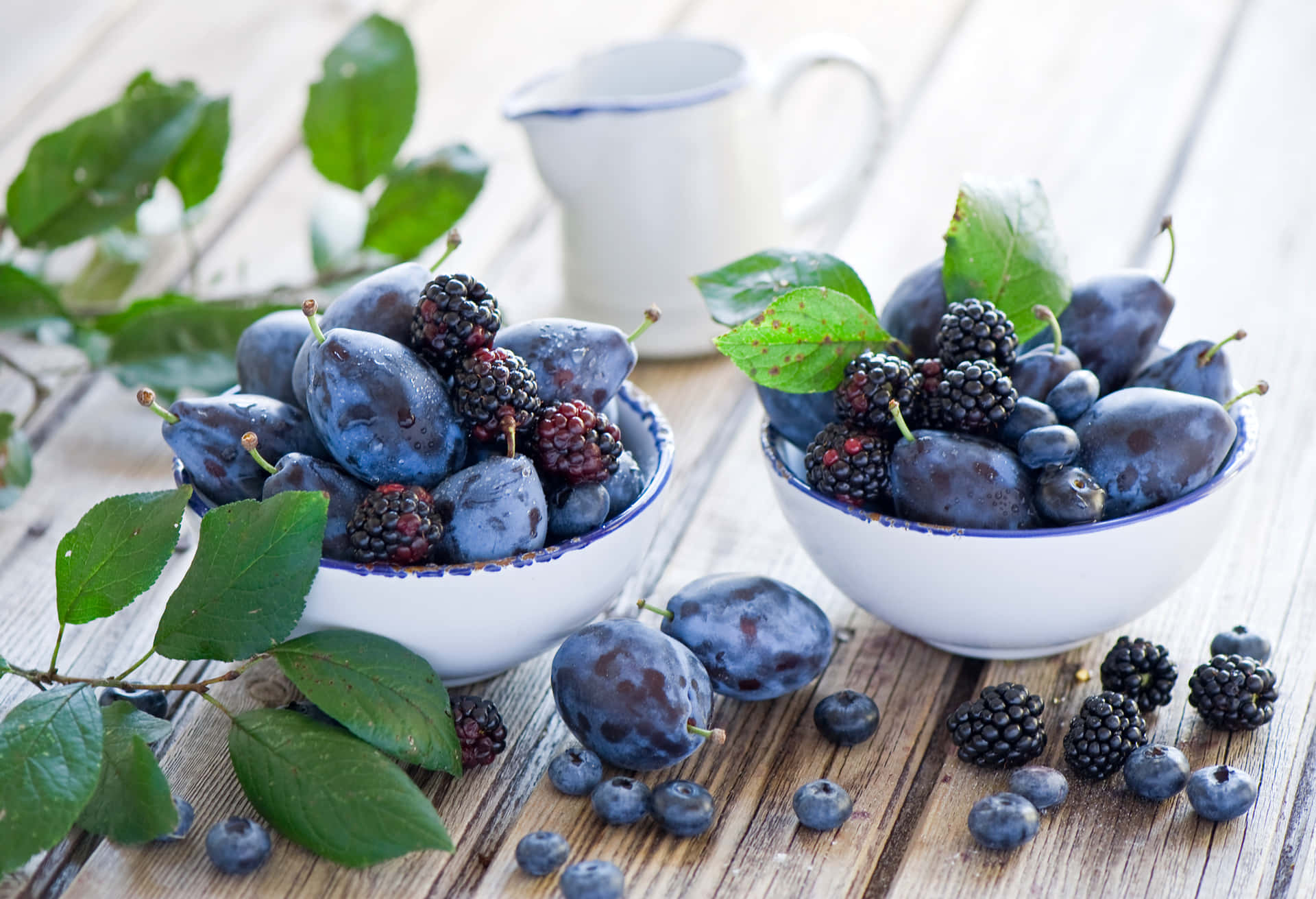 A Bountiful Harvest Of Italian Prune Plums And Fresh Blackberries Background