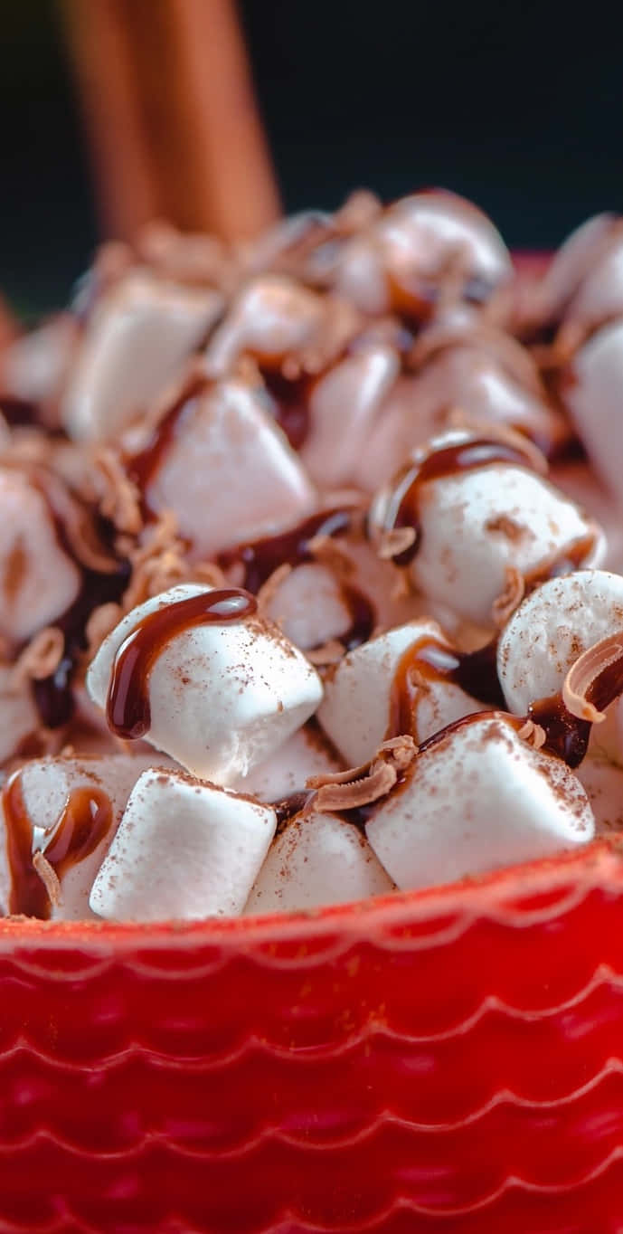 A Bowl Of Marshmallows And Chocolate In A Red Bowl Background