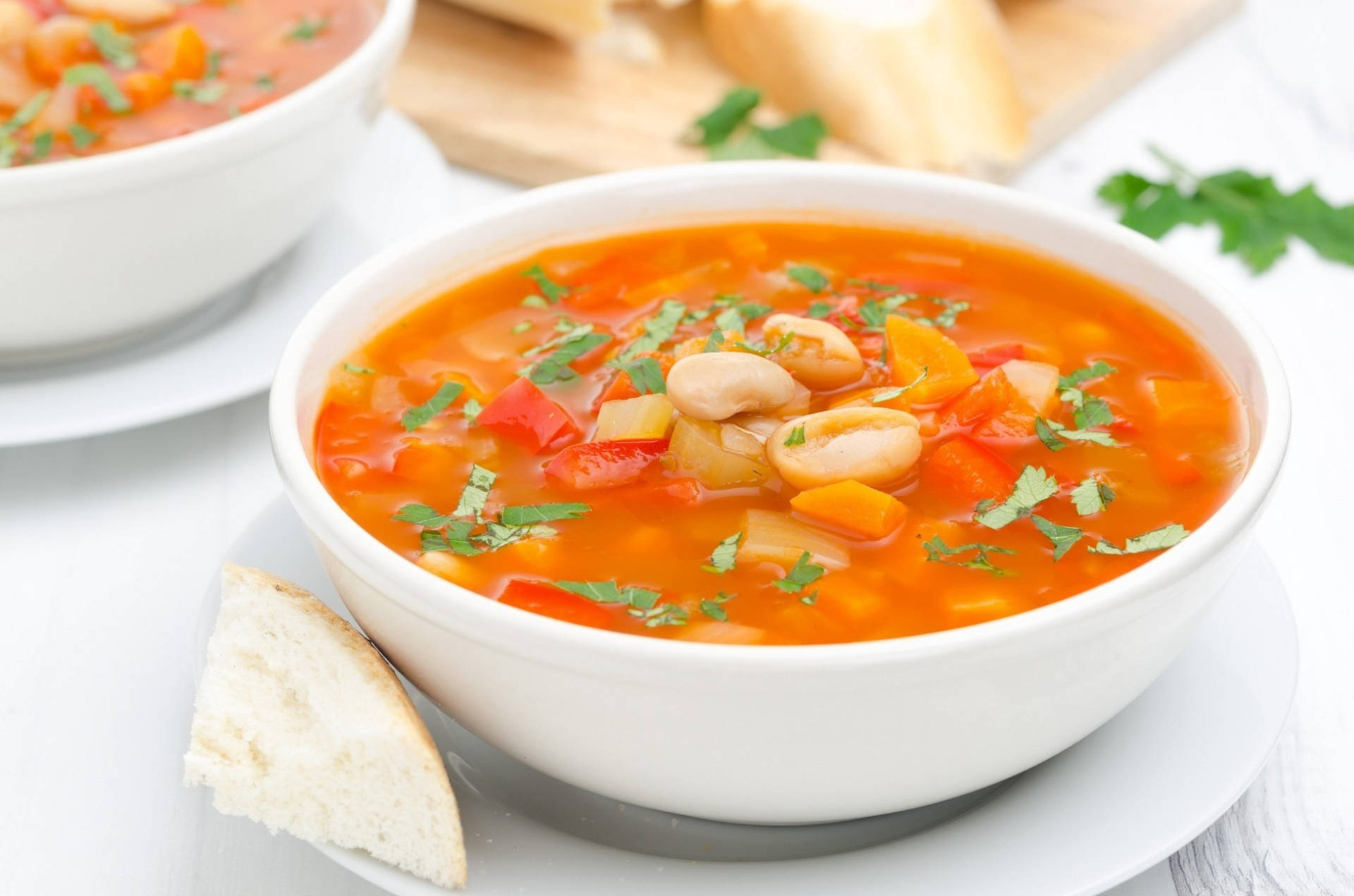 A Bowl Of Nutritious Vegetable Soup With White Beans Background