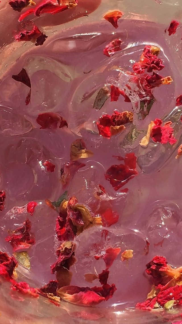 A Bowl Of Water With Rose Petals Floating In It Background