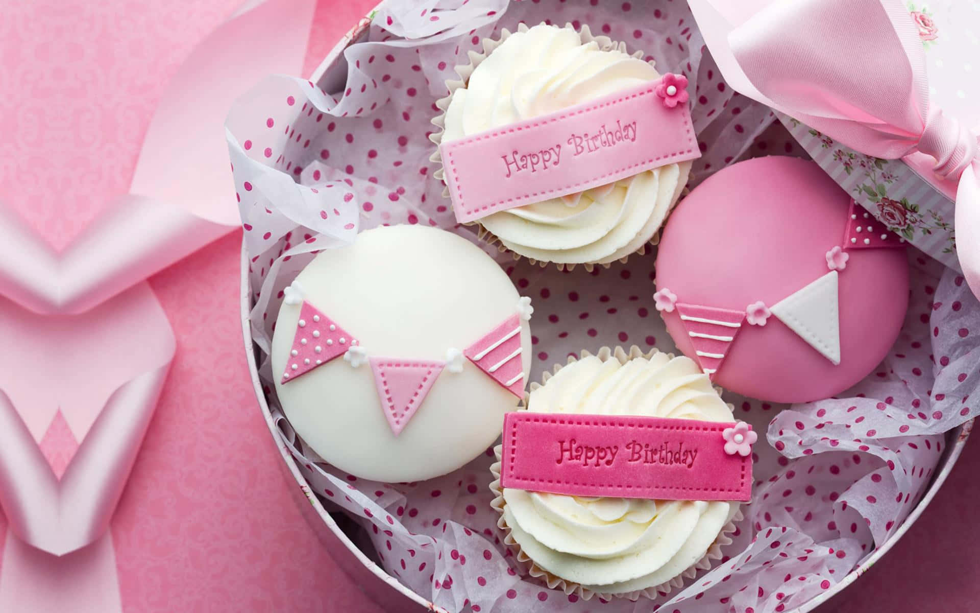 A Box Of Cupcakes With Pink Ribbons And Bows Background