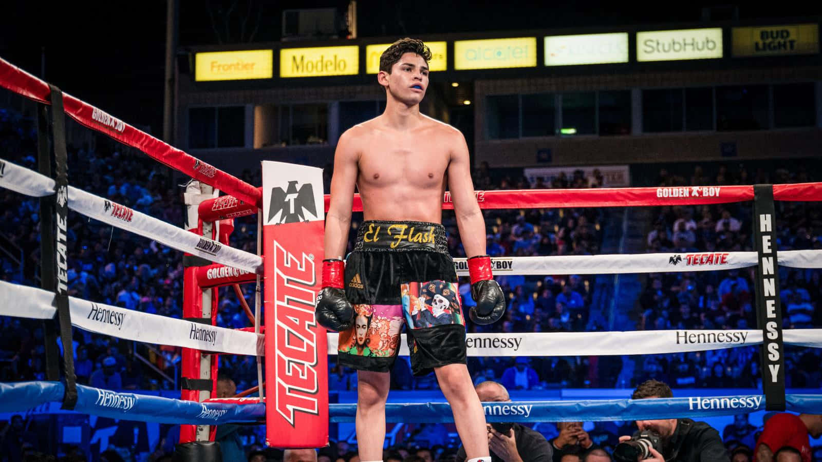 A Boxer Standing In The Ring With His Hands Raised Background