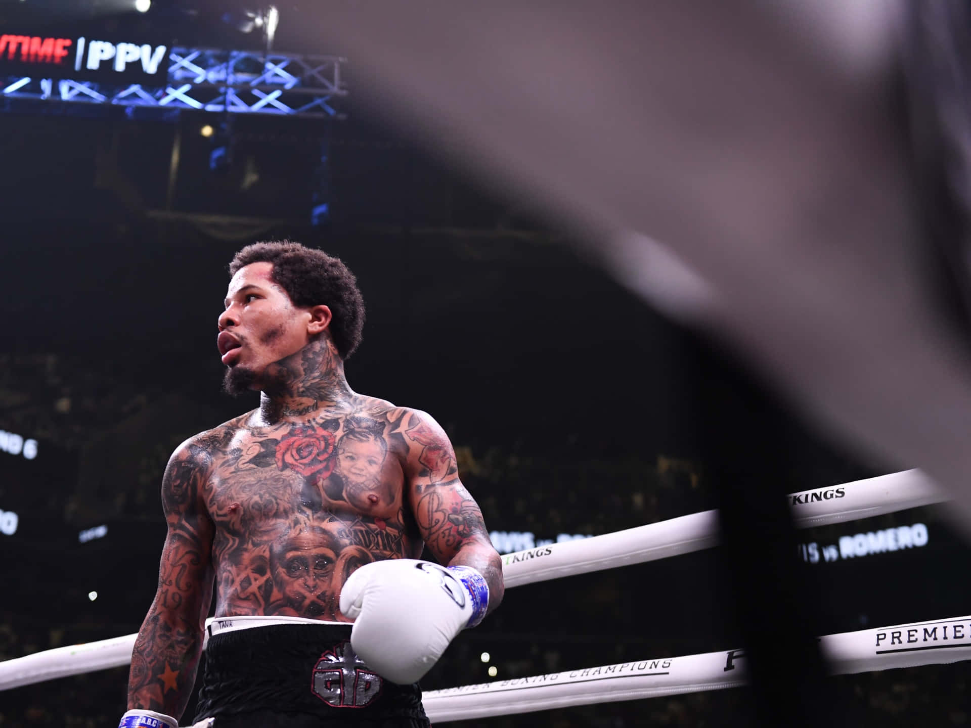 A Boxer With Tattoos Standing In The Ring Background