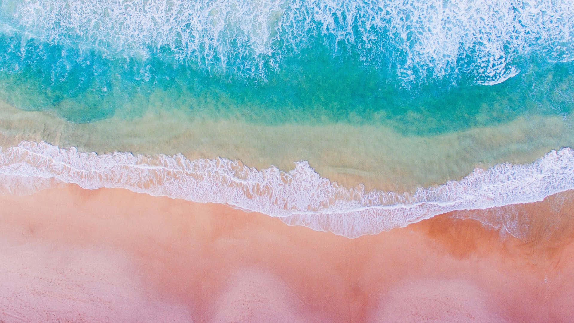 A Breathtaking View Of Pink Beach, Where Turquoise Waters Meet Rosy Sands. Background