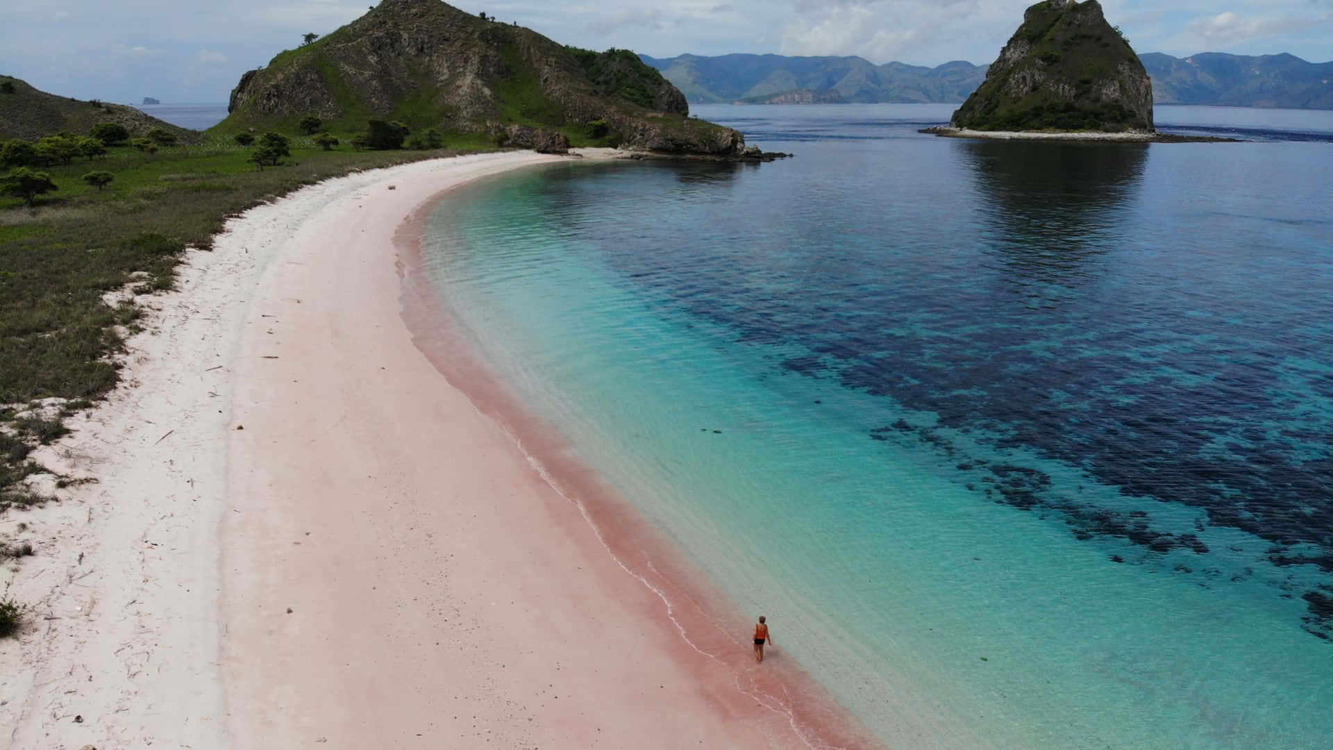 A Breathtaking View Of The Serene Pink Beach Background