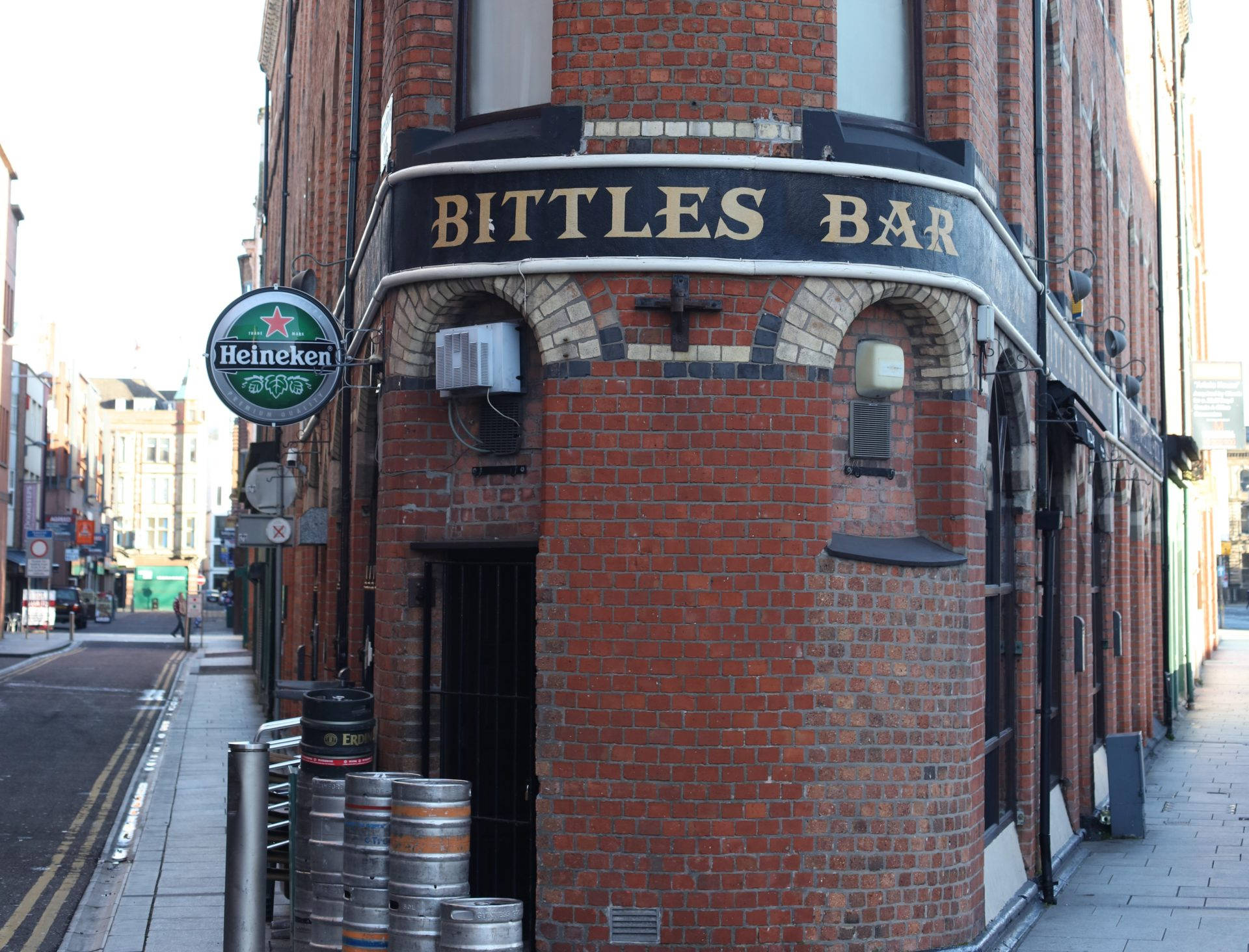 A Brick Building With A Sign Background