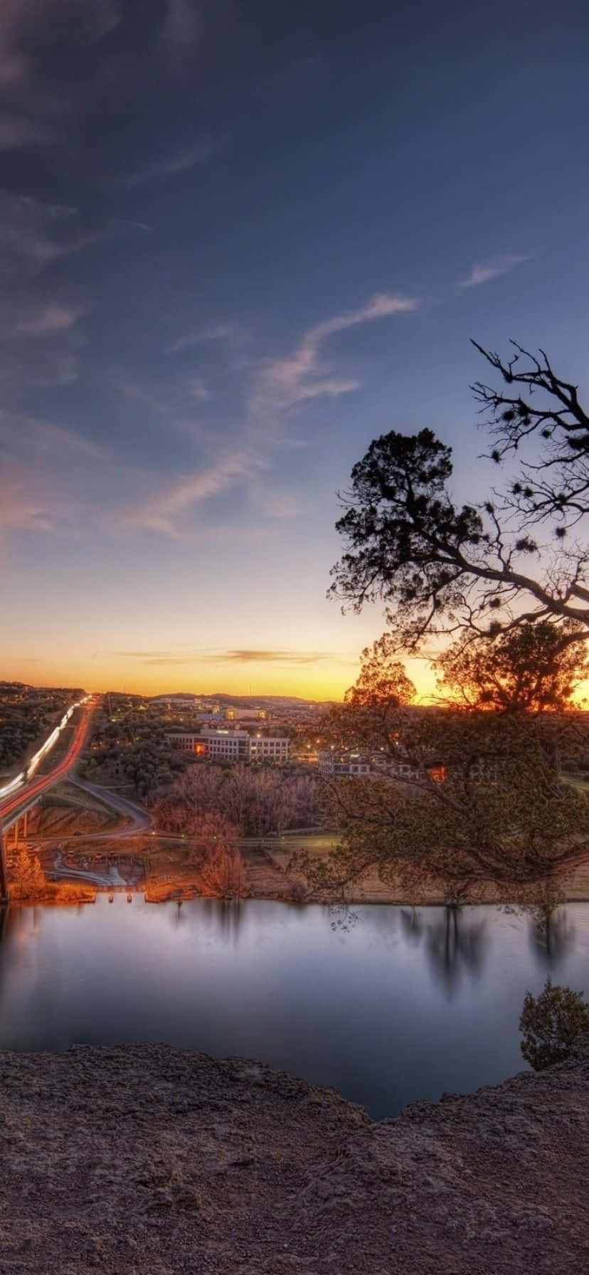 A Bridge Over A River At Sunset Background