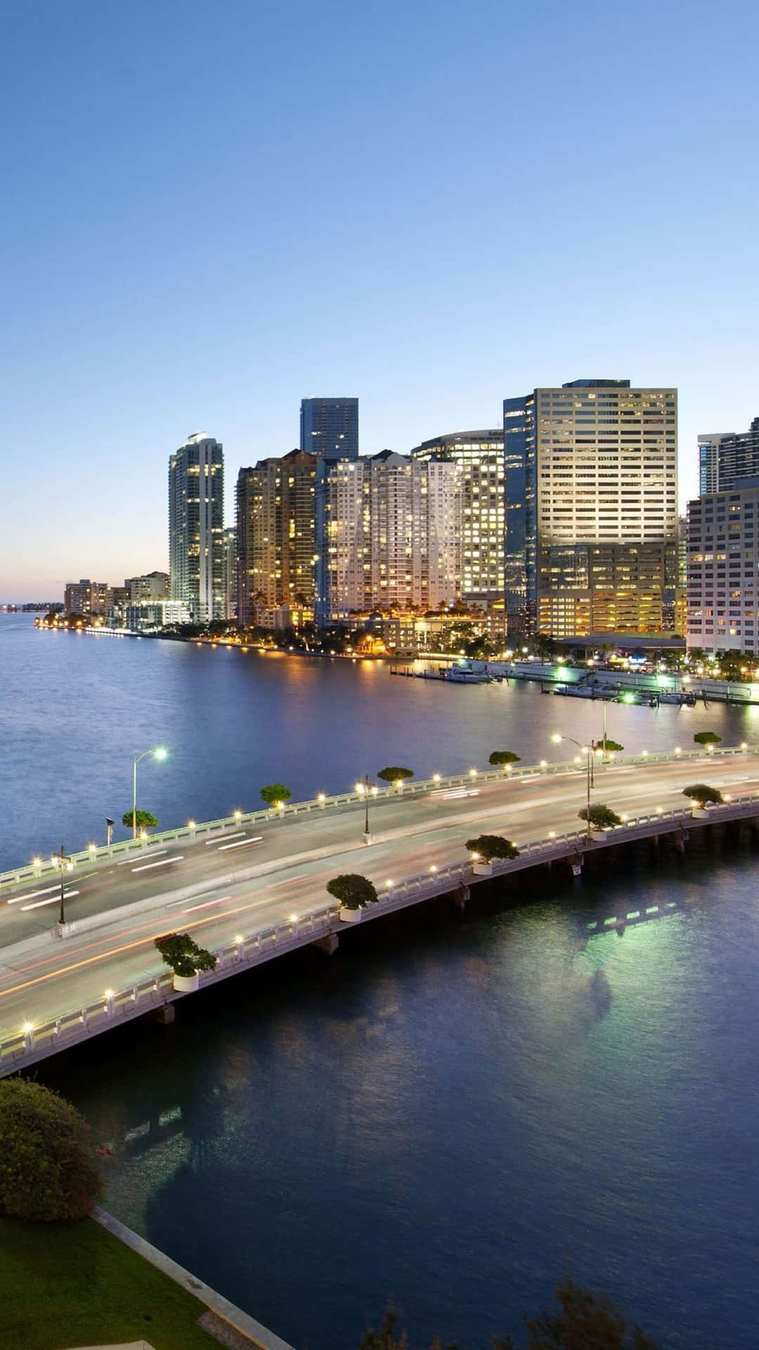 A Bridge Over The Water With Buildings And Skyscrapers Background