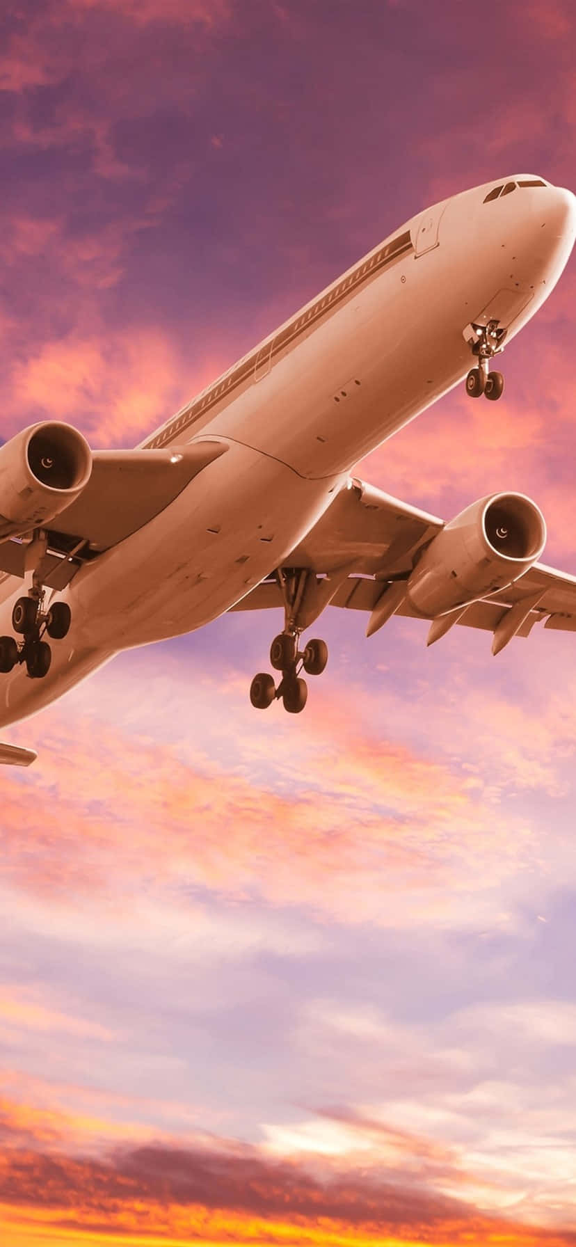 A Bright Pink Plane Soars Against A Blue Sky. Background