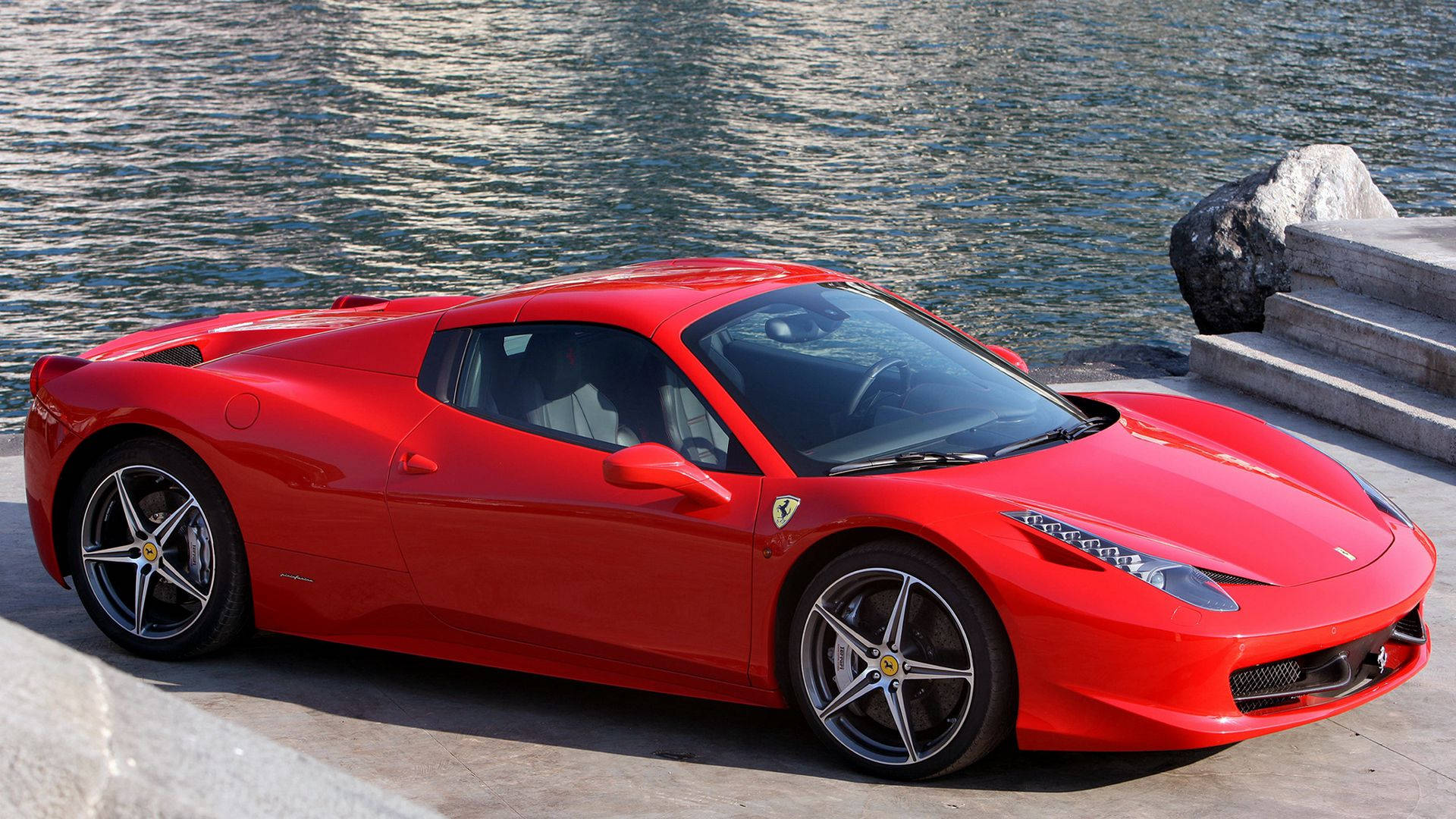 A Bright Red Ferrari Ferries Fast Along The Open Highway Background