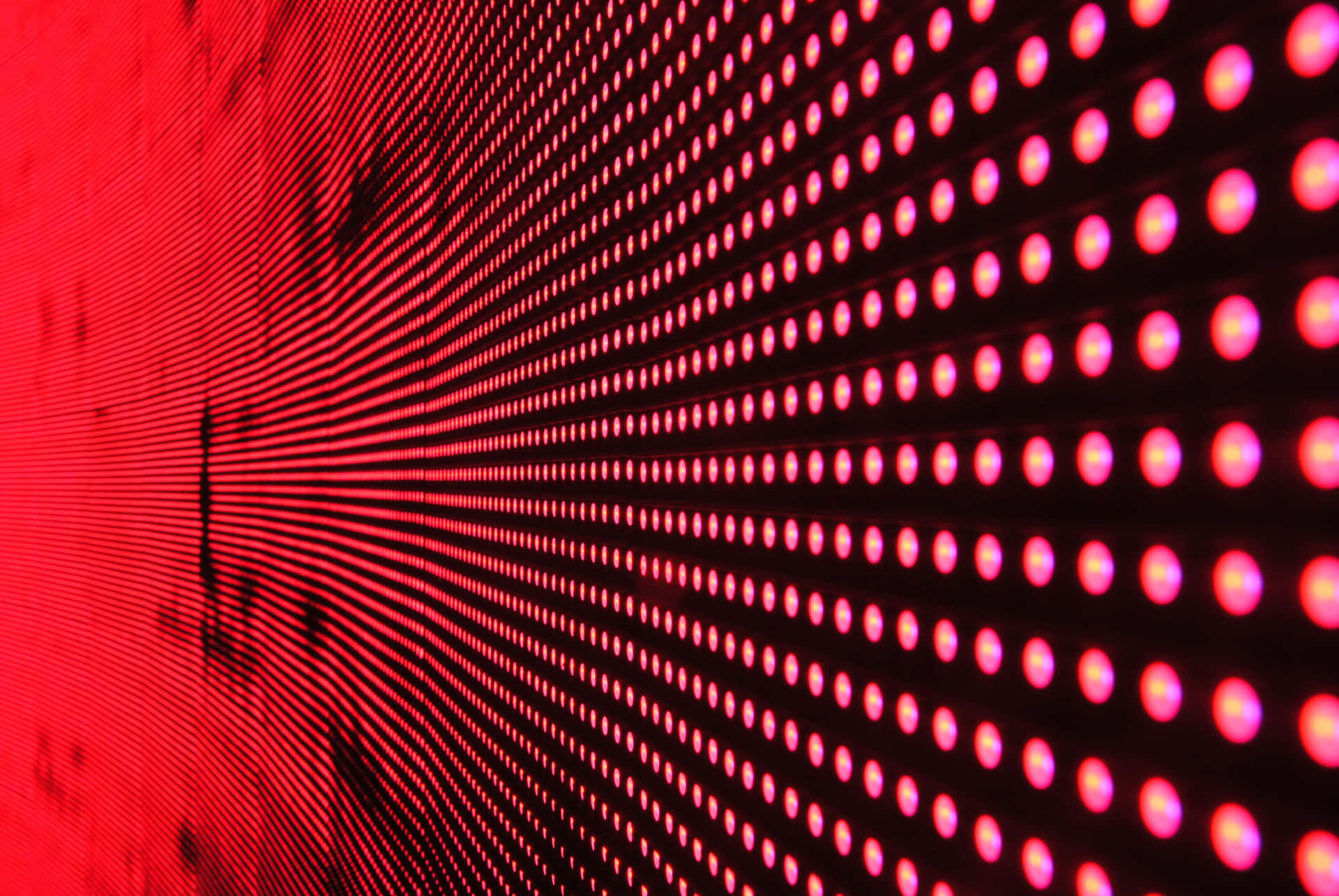A Bright Red Led Lightshines Onto A Wall Background