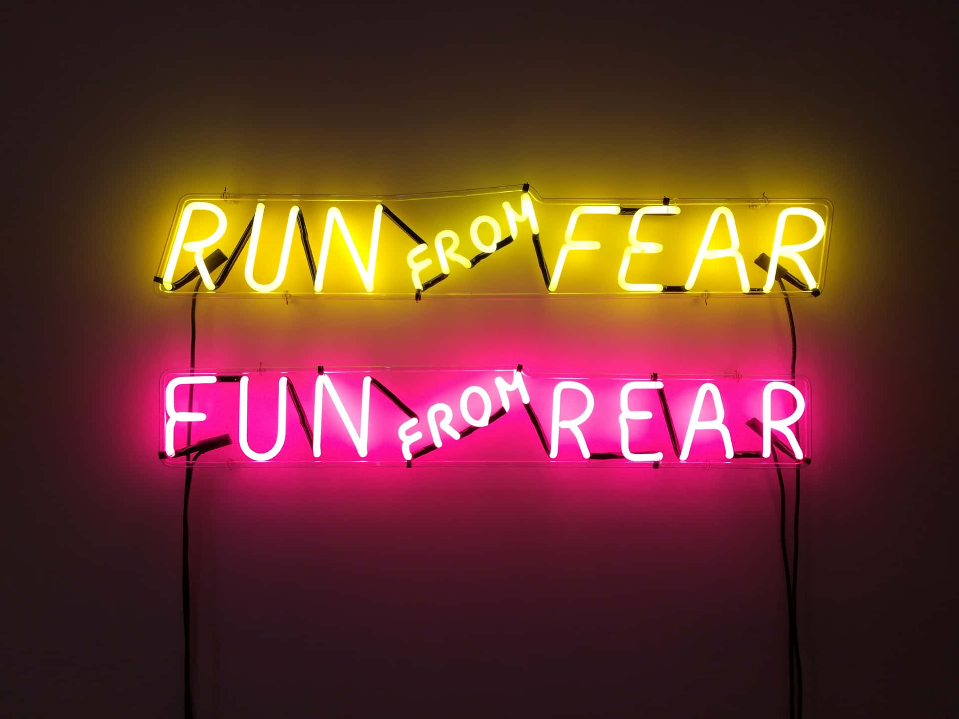 A Bright Yellow Neon Light Brightens Up The Dark Night Background