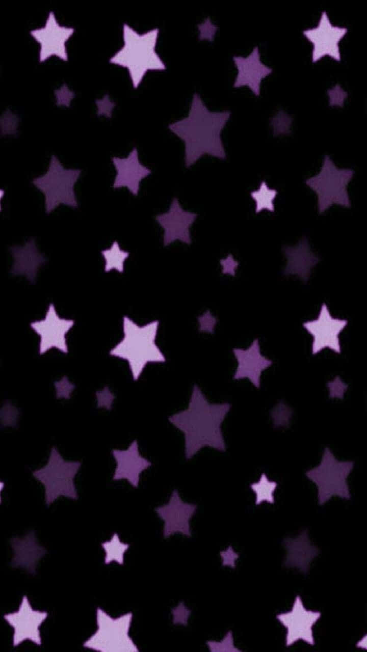 A Brilliant Five-pointed Purple Star Surrounded By Glimmering Sparkles Background