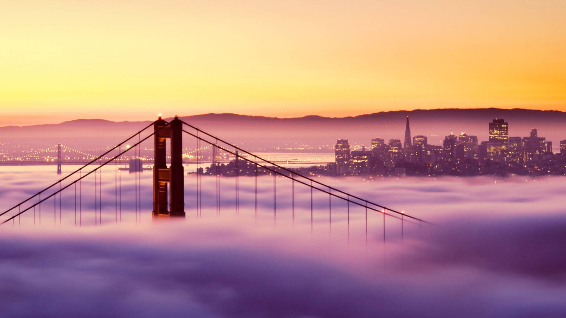 “a Brilliant Nighttime View Of San Francisco From The Golden Gate Bridge” Background