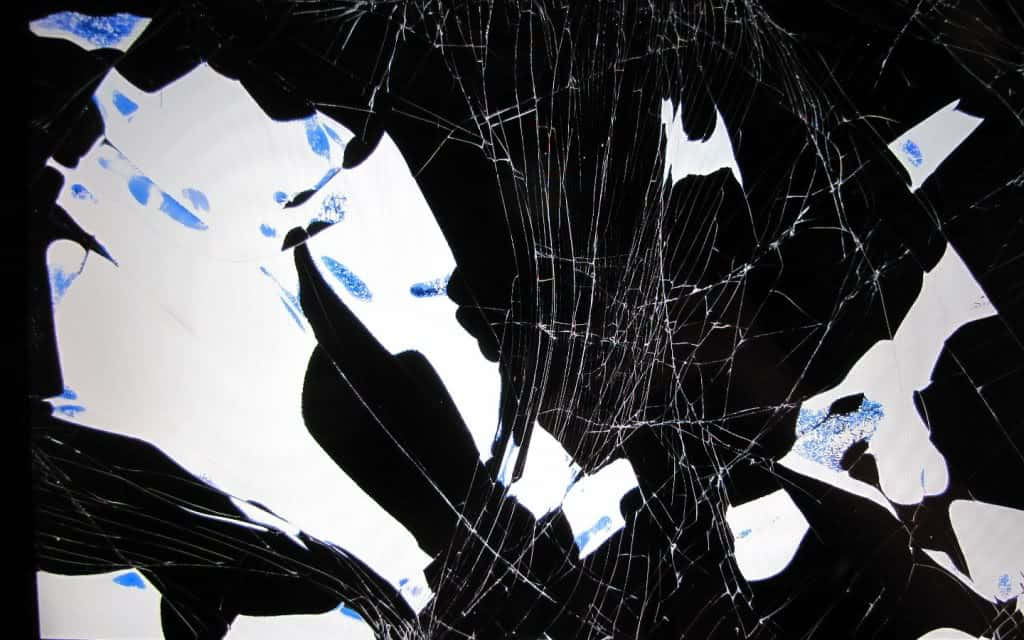 A Broken Window With Blue And White Shattered Glass Background