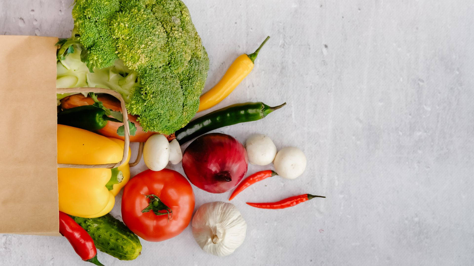 A Brown Bag Filled With Fresh Grocery Items Background