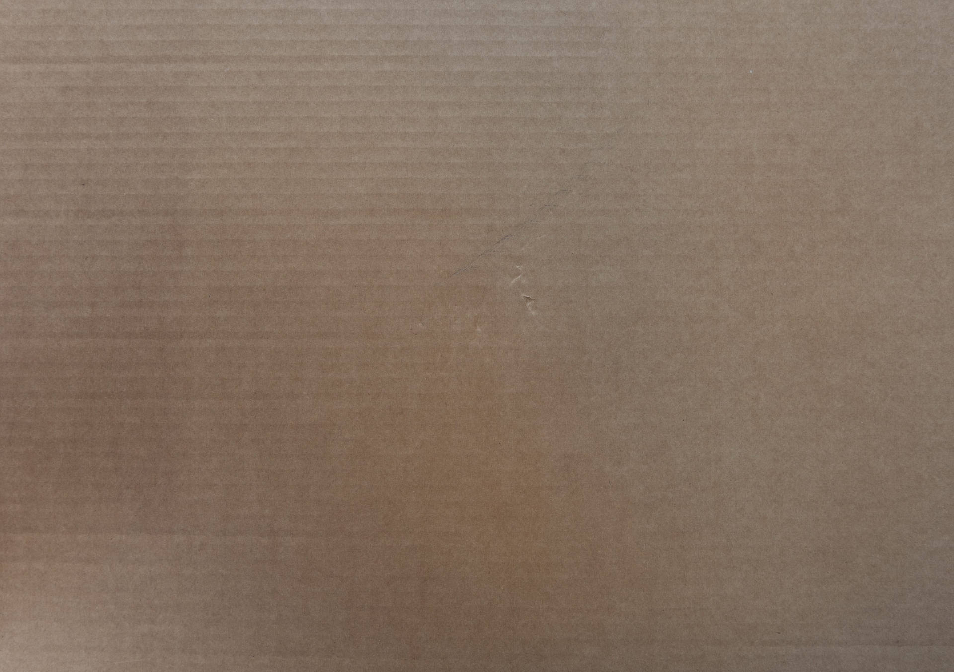 A Brown Cardboard Box With A Hole In It Background