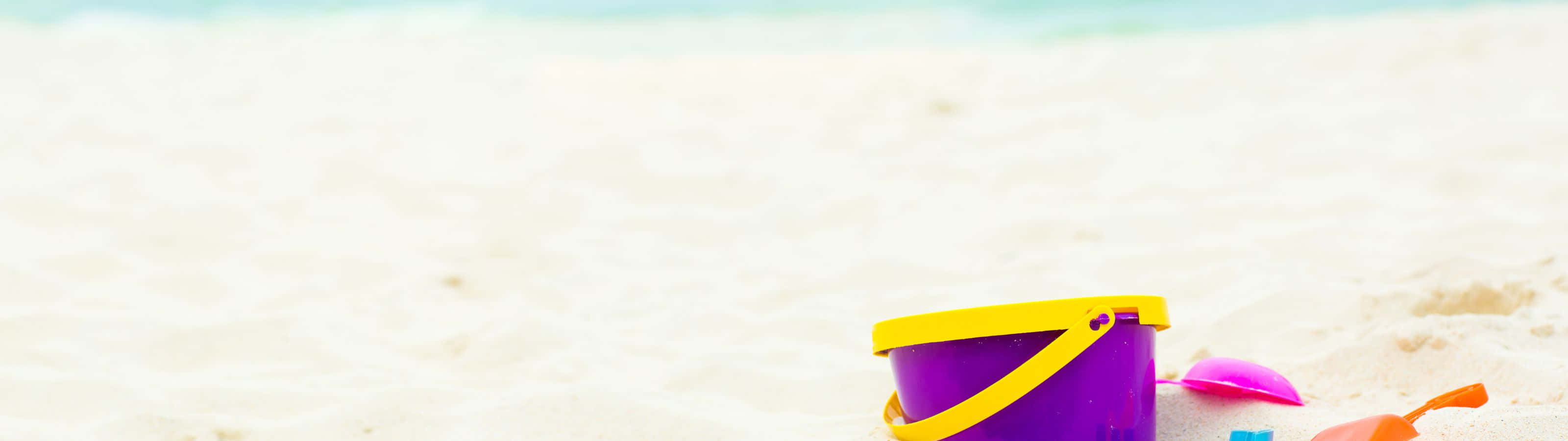 A Bucket And A Sandcastle In The Sand Background