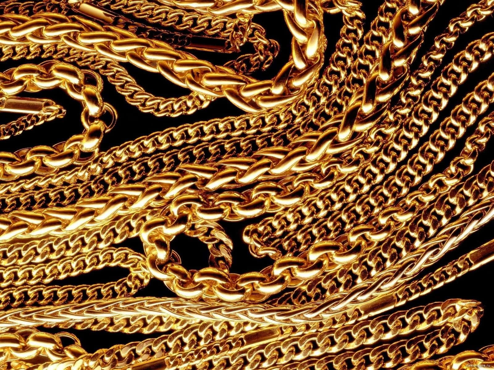 A Bunch Of Gold Chains On A Black Background Background