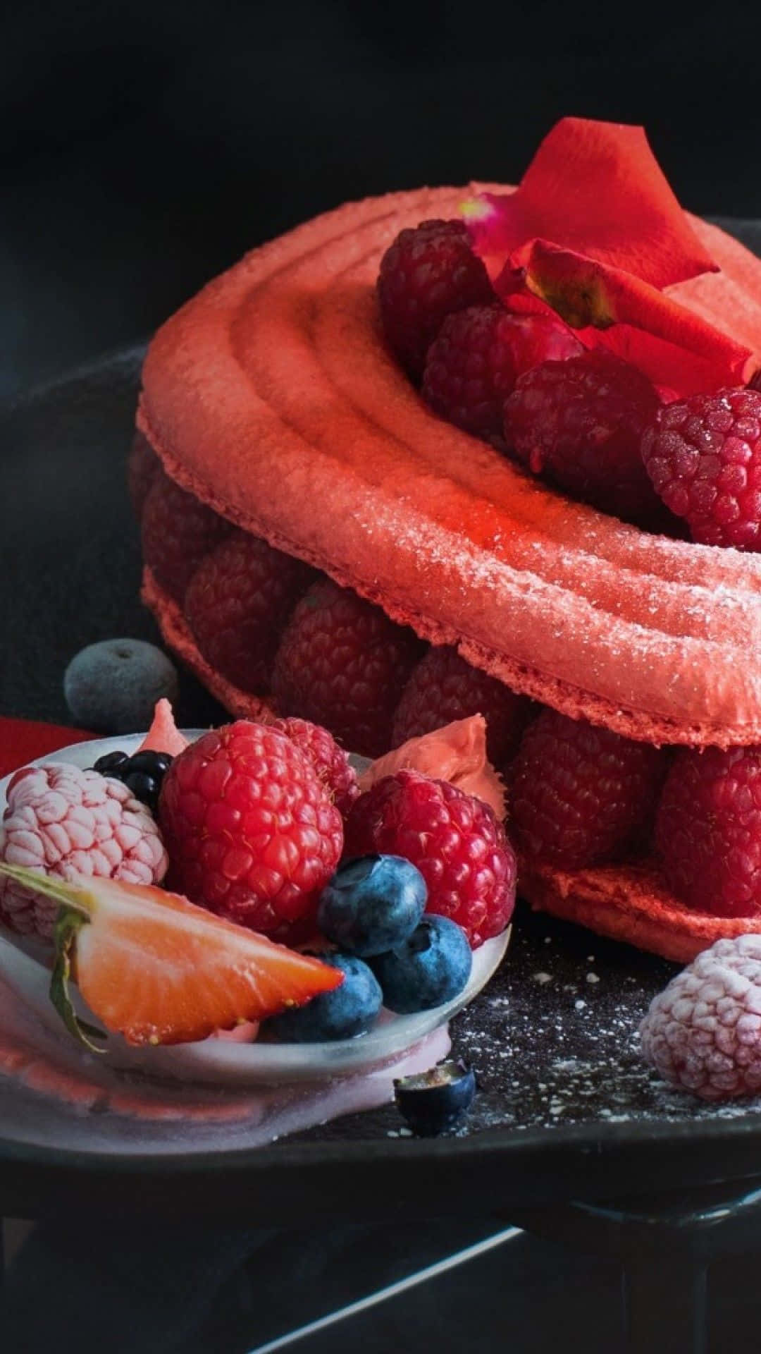 A Cake With Berries And Raspberries On A Plate Background