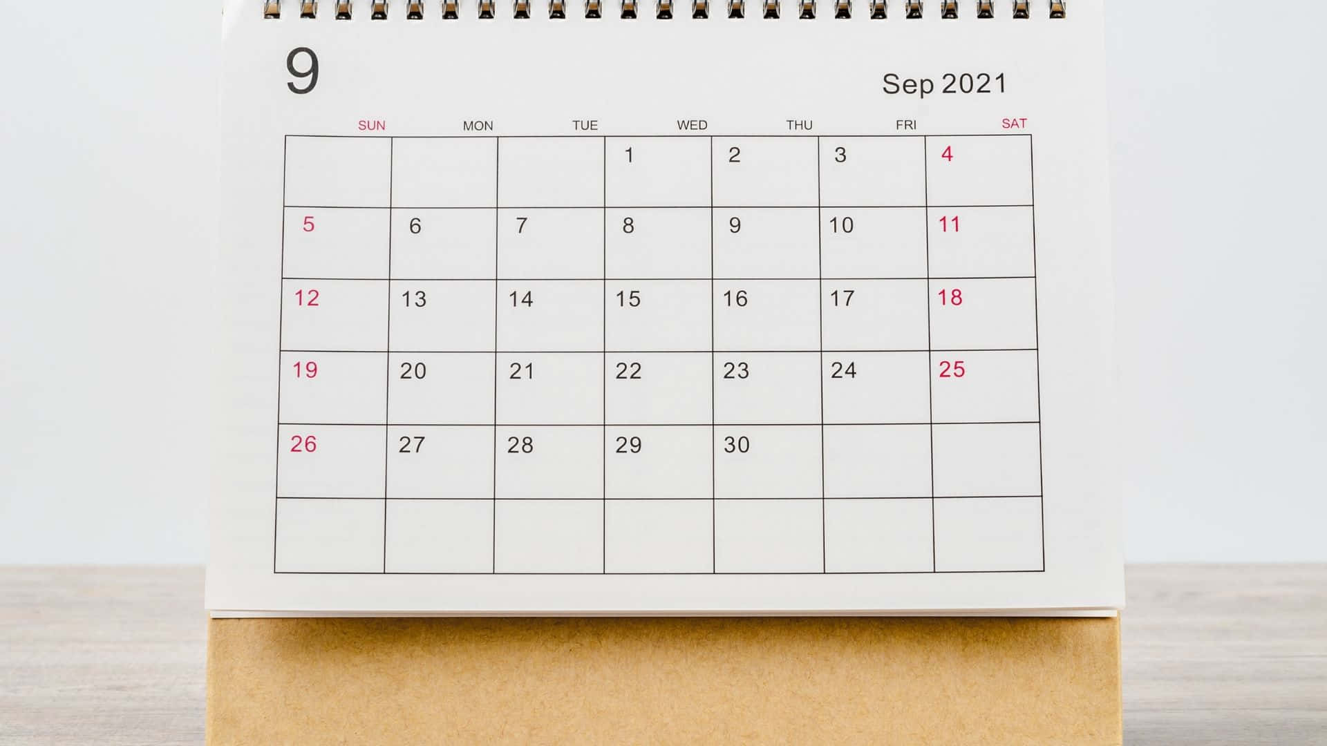 A Calendar With A White Background On A Wooden Table Background