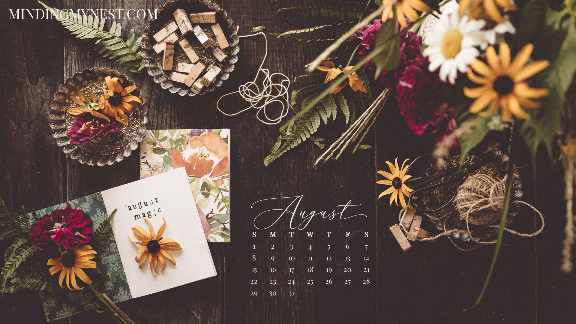 A Calendar With Flowers And A Notebook On It Background