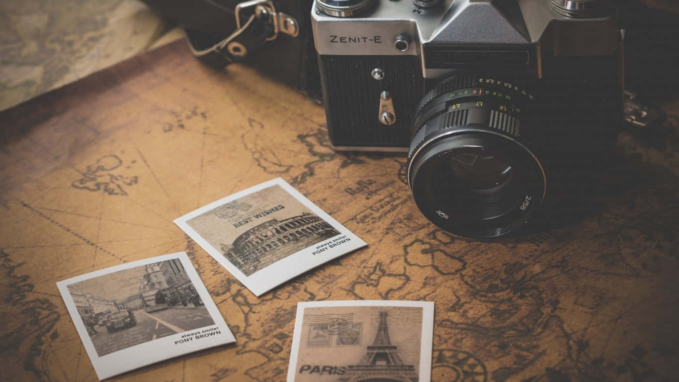 A Camera And A Map With Photos On It Background