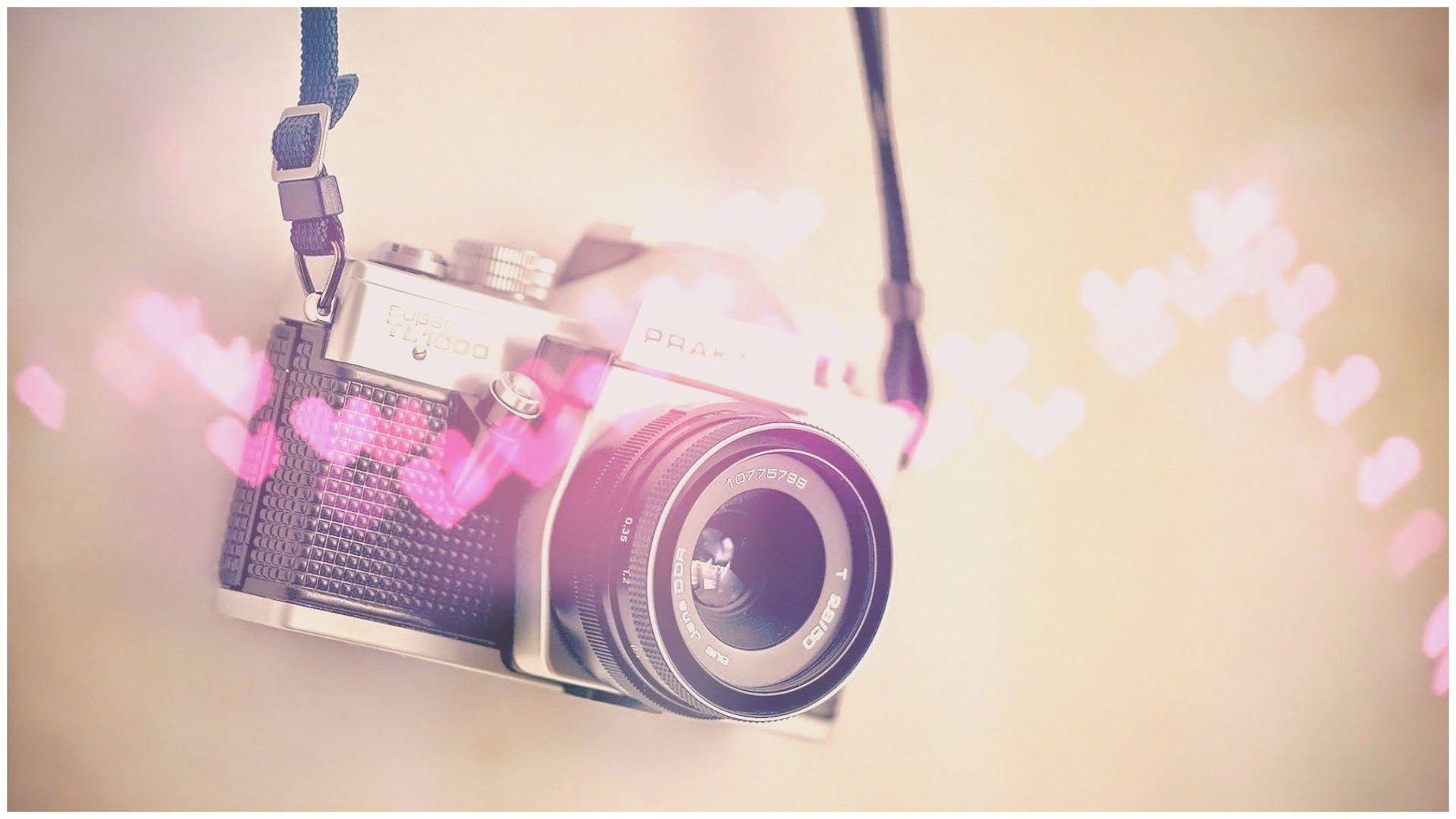 A Camera With Hearts Hanging From It Background