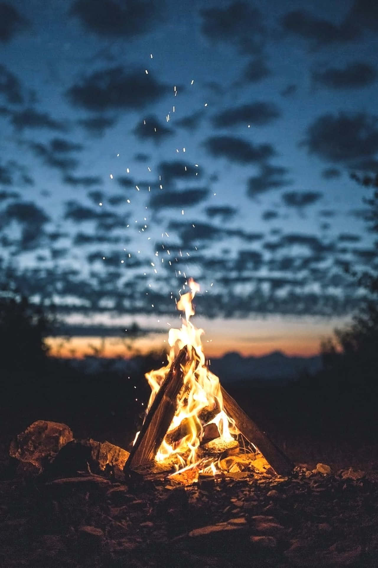 A Campfire Lit Up In The Night Sky