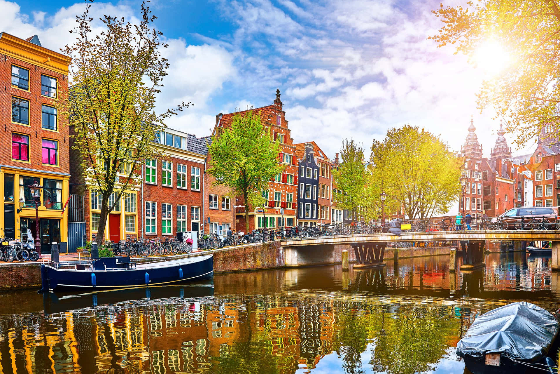 A Canal With Boats Parked In It Background